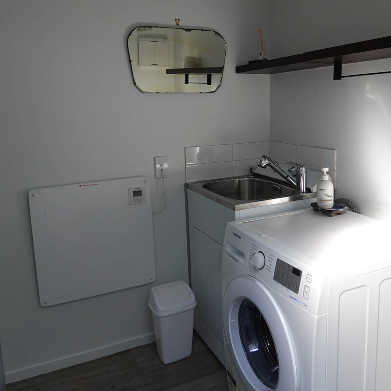The "outhouse" has a tub and washing machine as well as toilet and shower
